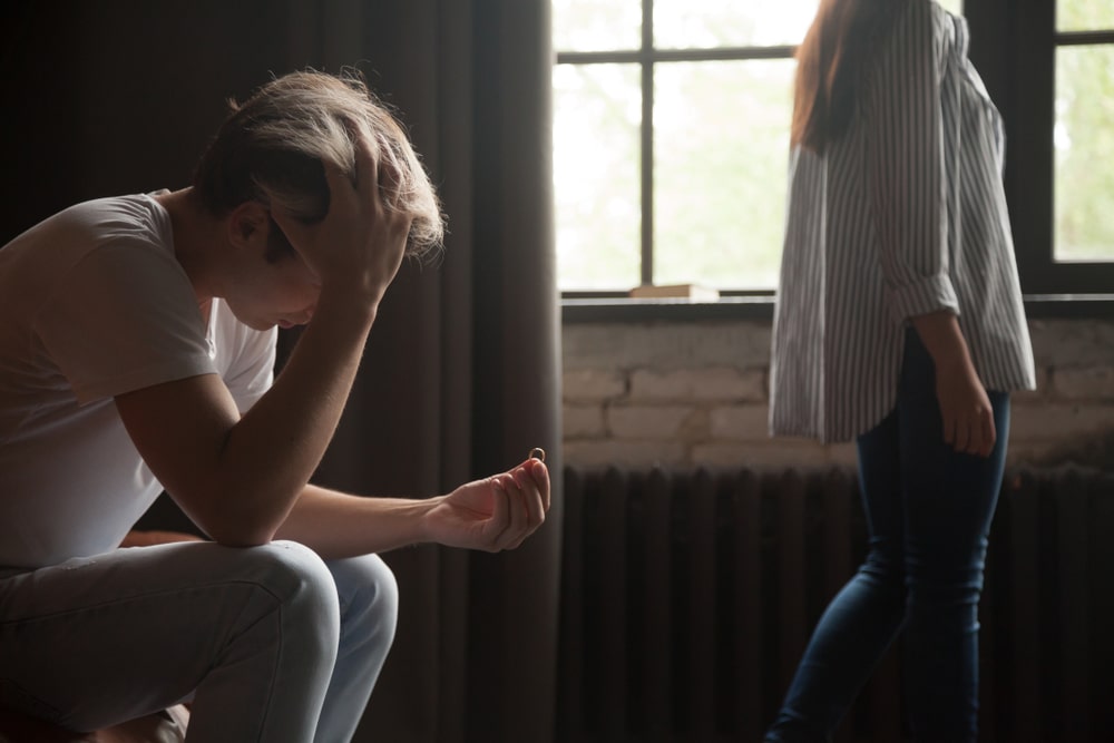 YoungFrustratedSadManHoldingWeddingEngagementRingWifeOr